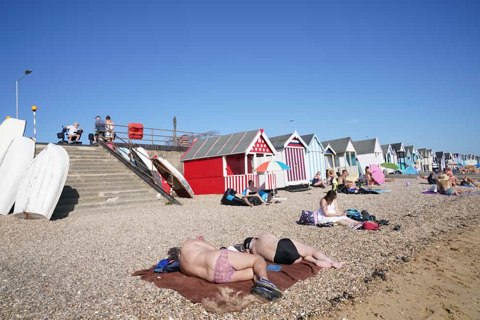People enjoy the warm weather on the beach at South End on Sea, Essex (Stefan Rousseau/PA)