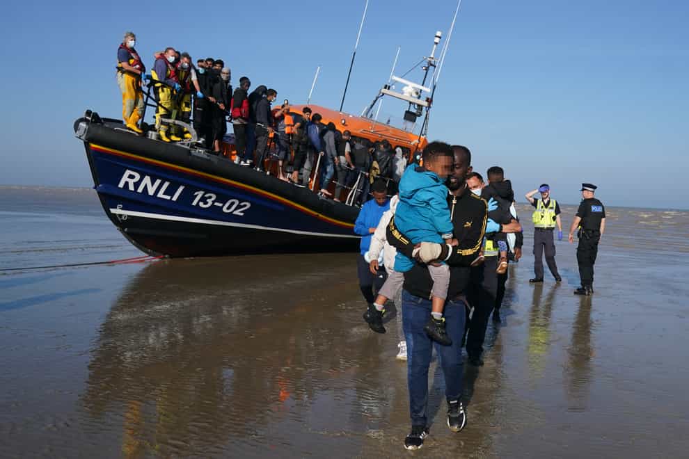 A group of people thought to be migrants are brought ashore at Dungeness in Kent (Gareth Fuller/PA)
