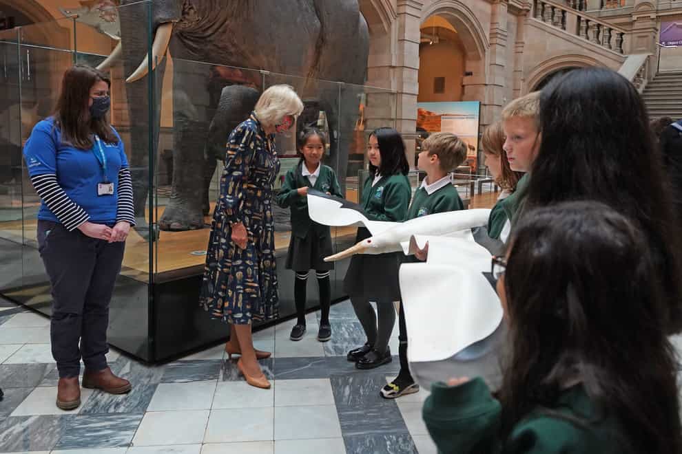 The Duchess of Cornwall (second left) talks to school children as they hold a model of an albatross during a visit to Kelvingrove Art Gallery and Museum in Glasgow (Andrew Milligan/PA)
