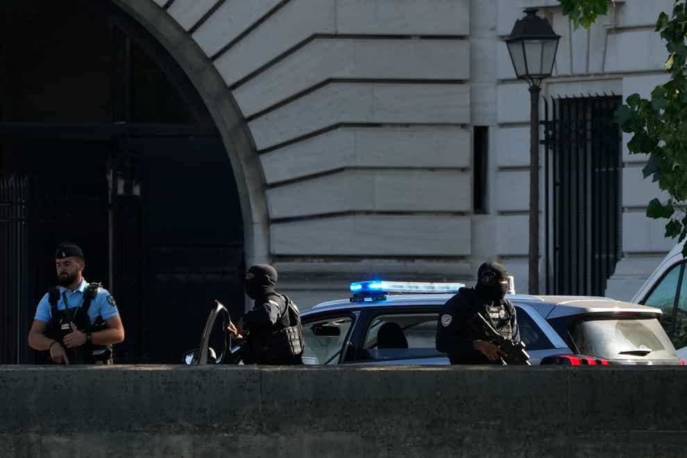 Security forces outside the Palais de Justice in Paris (Francois Mori/AP)