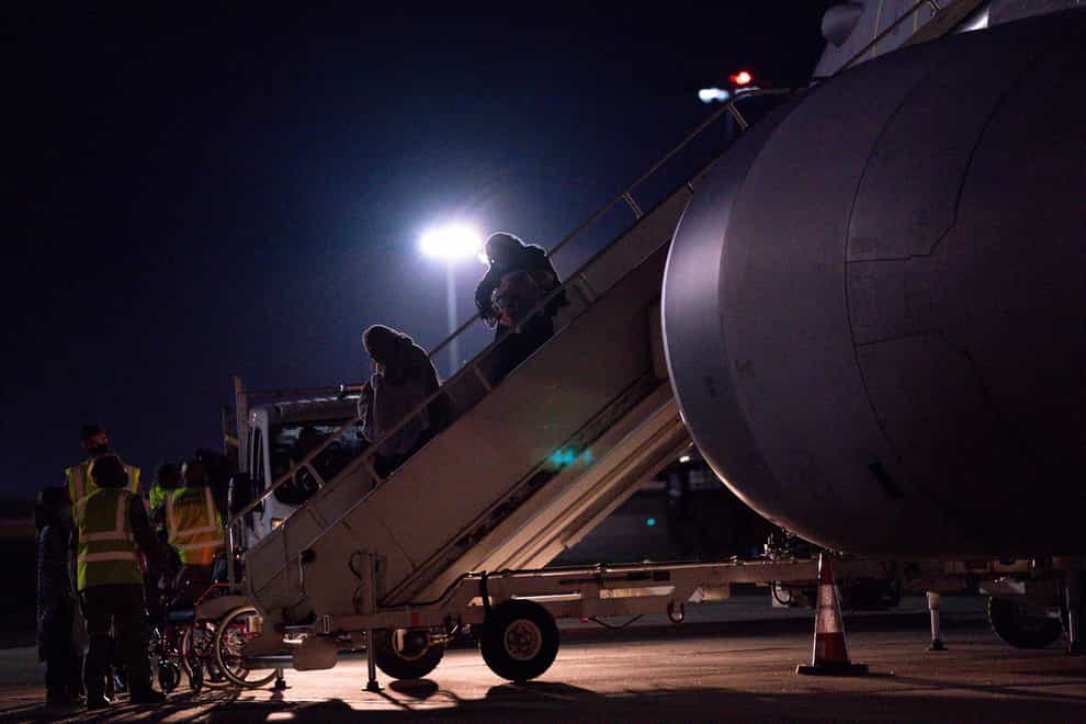British nationals and Afghan arrive on a flight from Afghanistan at RAF Brize Norton (Jacob King/PA)