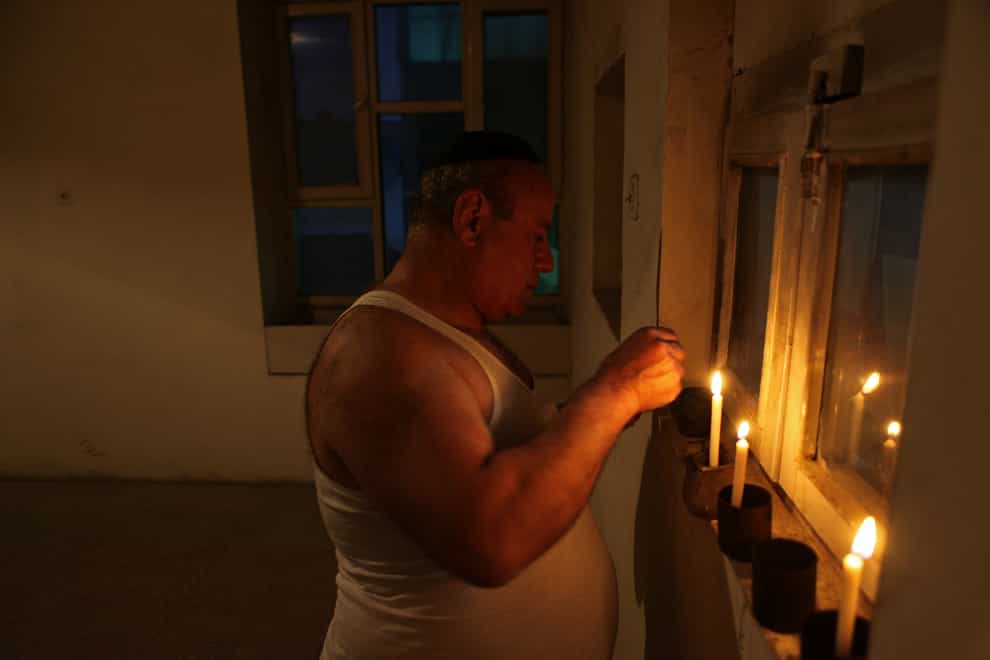 Zebulon Simentov, the last known Jew living in Afghanistan, lights the candles in 2009 at the start of Shabbat in the synagogue he cared for in Kabul (David Goldman/AP)