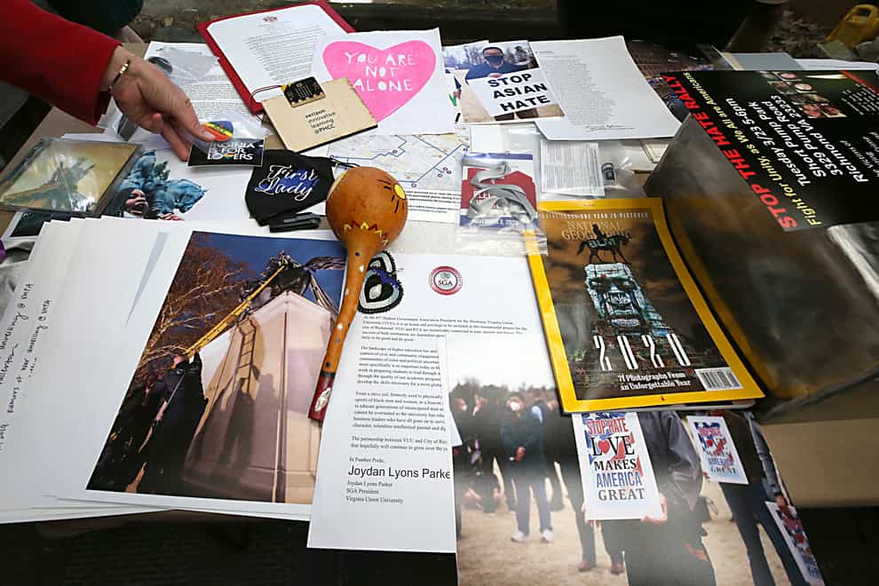 Some of the 39 items placed inside a time capsule in Richmond, Virginia. The time capsule will replace one believed to be in the base of the Robert E. Lee statue (Bob Brown/Richmond Times-Dispatch via AP)