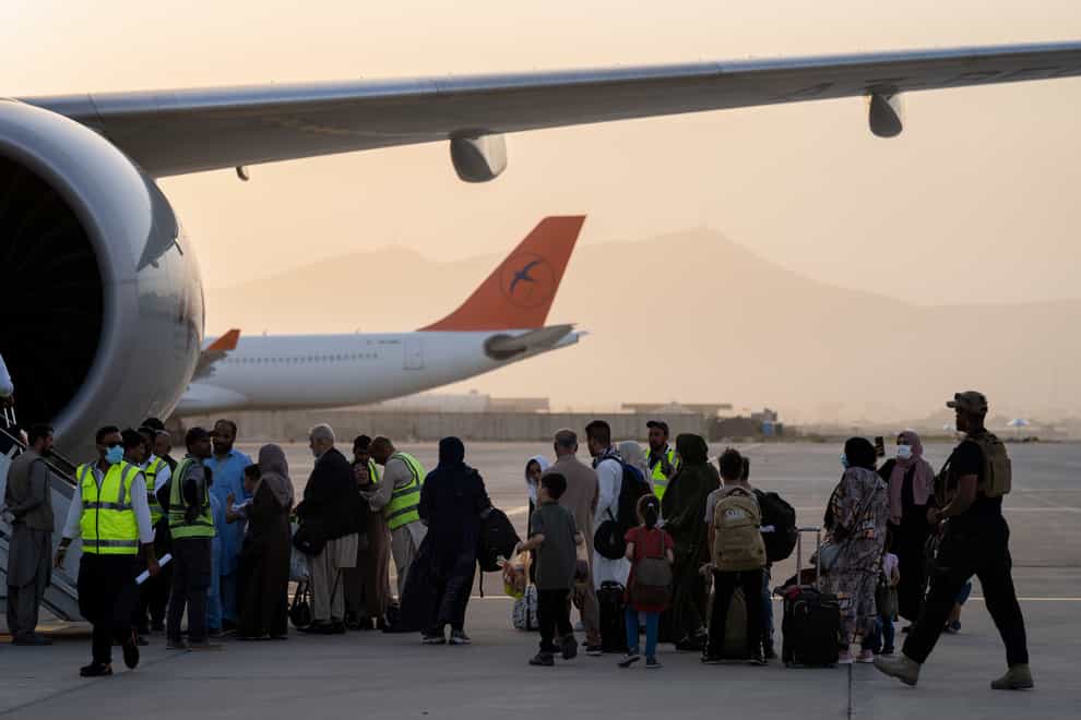 Foreigners board a Qatar Airways aircraft at the airport in Kabul, Afghanistan (AP Photo/Bernat Armangue)
