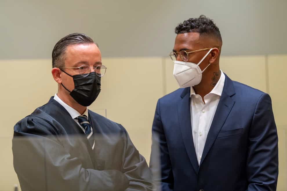 Jerome Boateng stands with his lawyer Kai Waldenat the beginning of the trial (Peter Kneffel /dpa via AP)