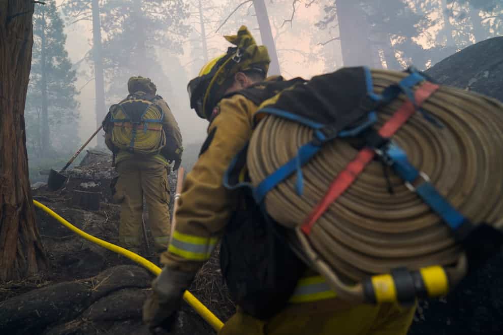 More than 14,600 firefighters were on the lines of 13 active, large wildfires in California. (AP Photo/Jae C. Hong)
