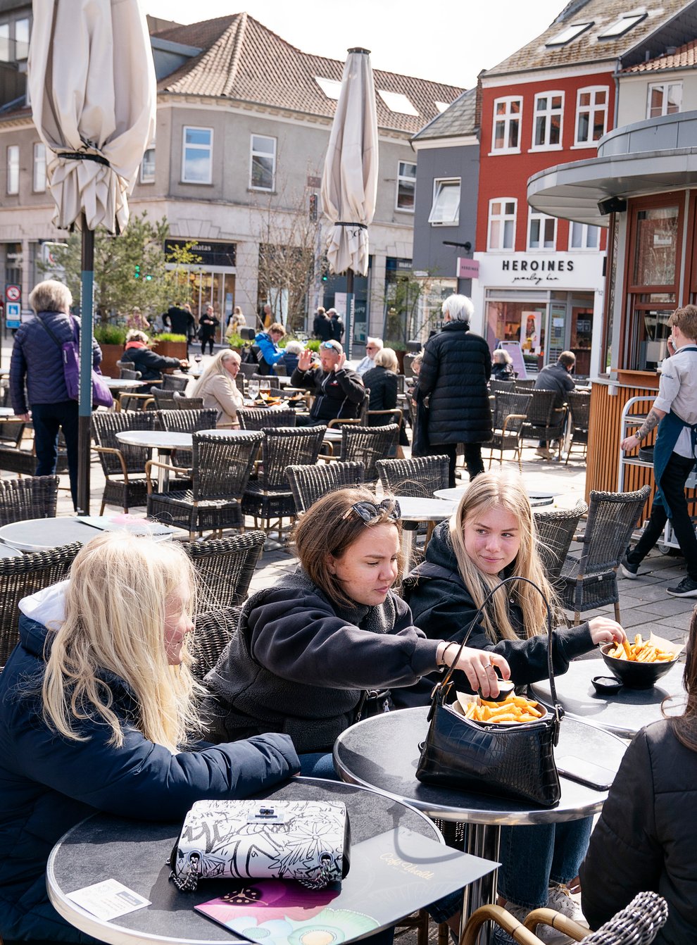 People sit outside a restaurant for outdoor service in Roskilde Denmark (Claus Bech/Ritzau Scanpix via AP, File)