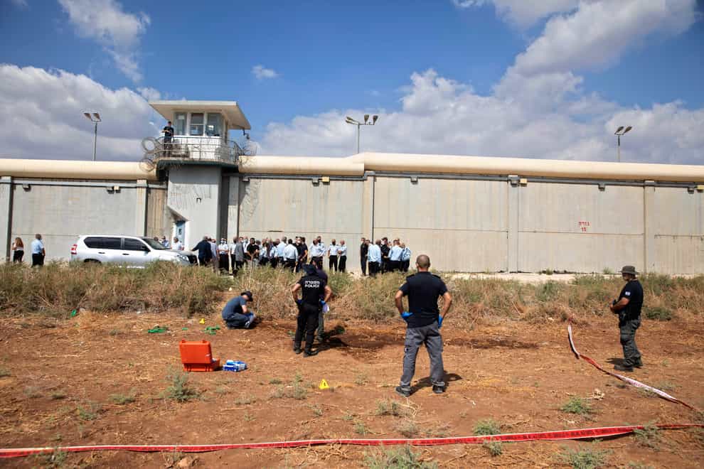 Police officers and prison guards inspect the scene of an escape (Sebastian Scheiner/AP)