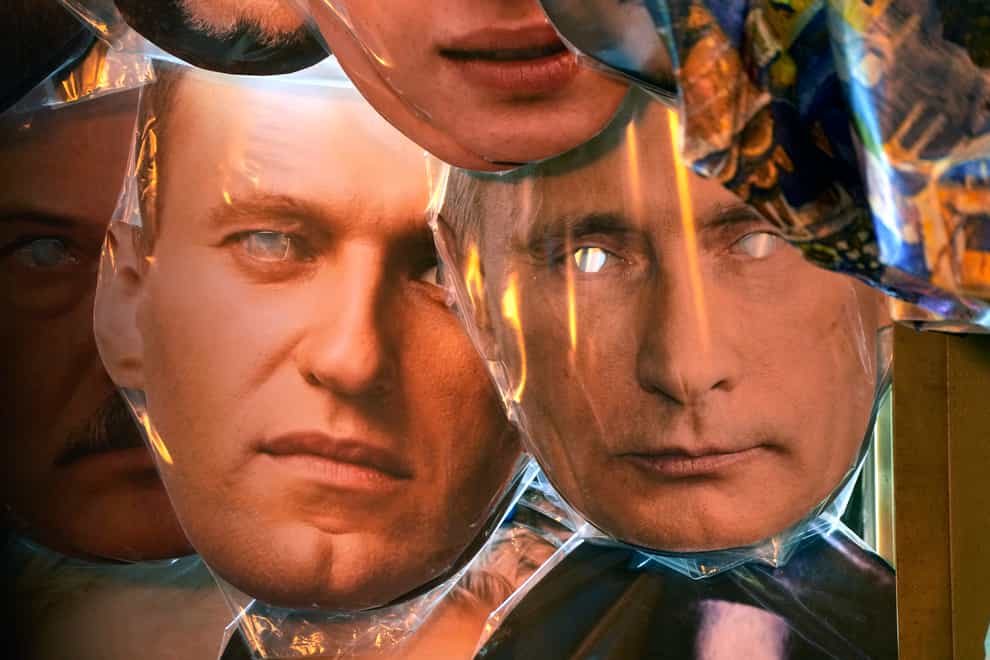 Face masks depicting Russian President Vladimir Putin, right, and jailed Russian opposition leader Alexei Navalny (Dmitri Lovetsky/AP)