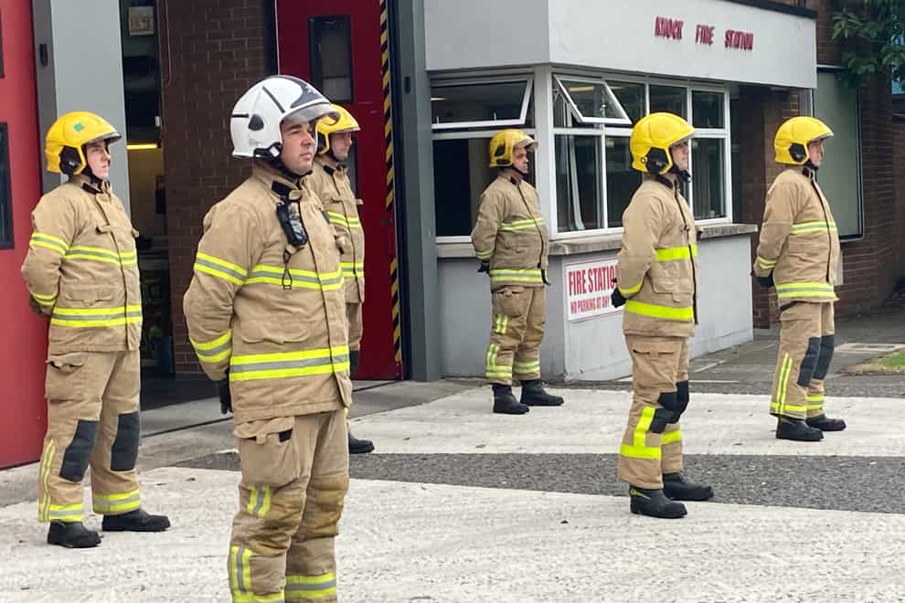 Firefighters at Knock Station in east Belfast stand for a minute silence in memory of those who lost their lives in the 9/11 terror attacks. (Rebecca Black/PA)