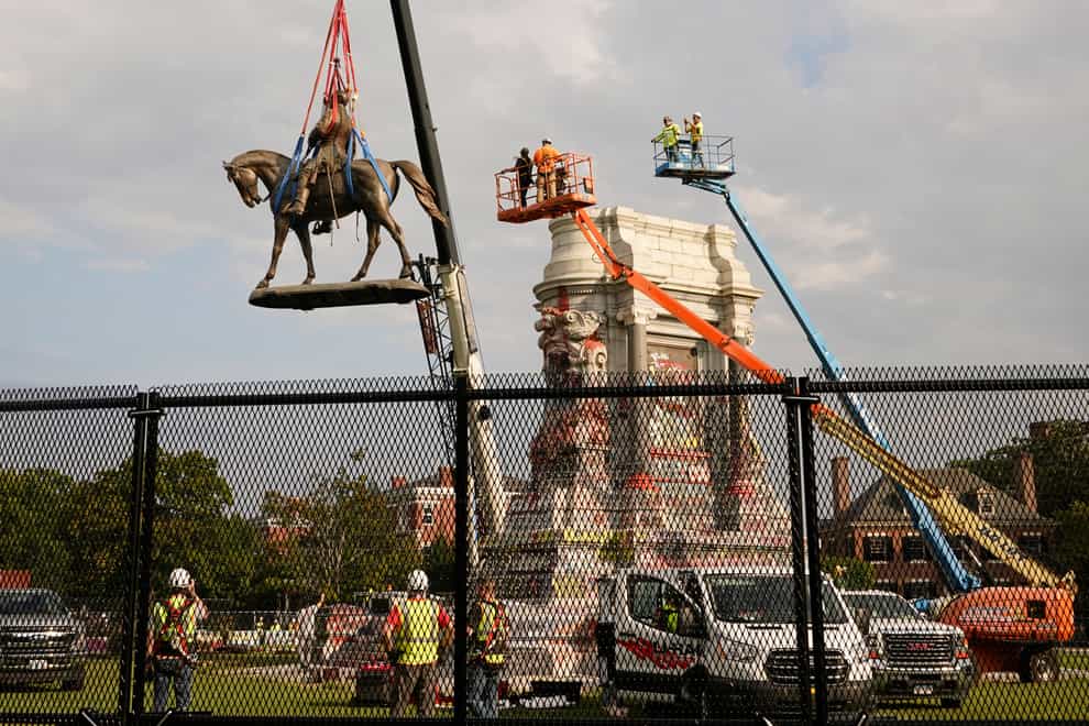 Crews remove one of the country’s largest remaining monuments to the Confederacy, a towering statue of Confederate General Robert E. Lee on Monument Avenue in Richmond, Virginia (Steve Helber/AP)