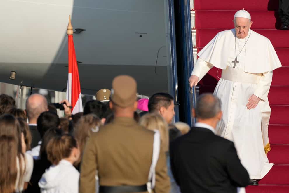 Pope Francis walks down the steps on an airplane as he arrives at Budapest international airport (Gregorio Borgia/AP)
