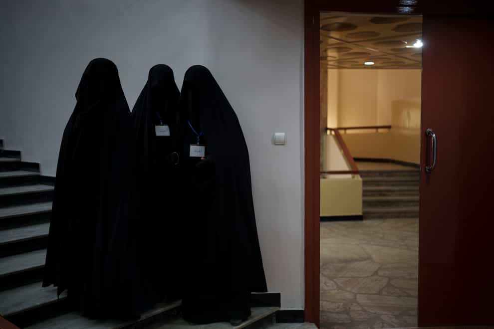 Women stand inside an auditorium at Kabul University’s education centre during a demonstration (Felipe Diana/AP)
