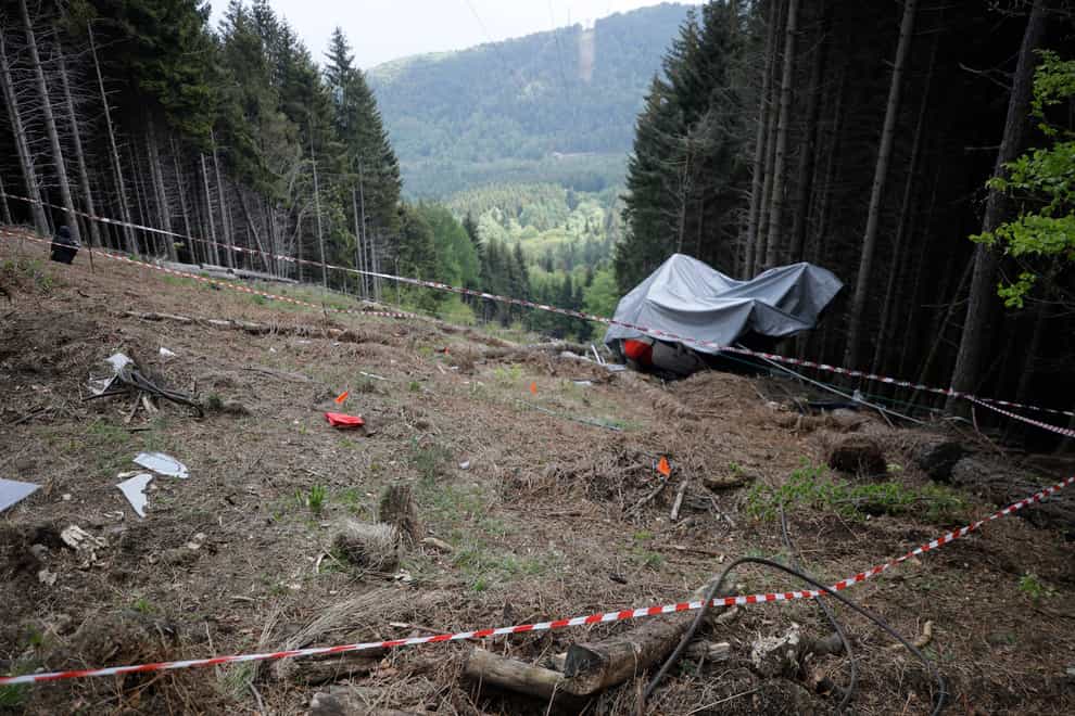 The wreckage of the cable car after it collapsed in the Piedmont region of northern Italy (Luca Bruno/AP)