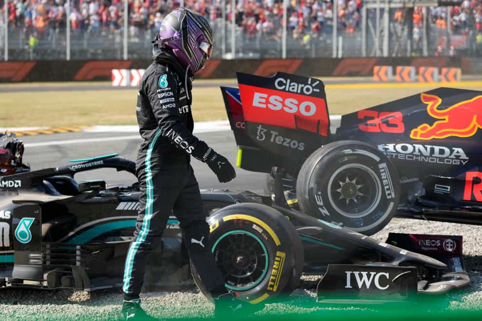 Lewis Hamilton walks away from his Mercedes after colliding with Max Verstappen (Luca Bruno/AP)