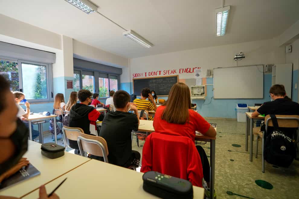 A teacher and students wear face masks during a lesson, at the Isacco Newton high school, in Rome (Andrew Medichini/AP)