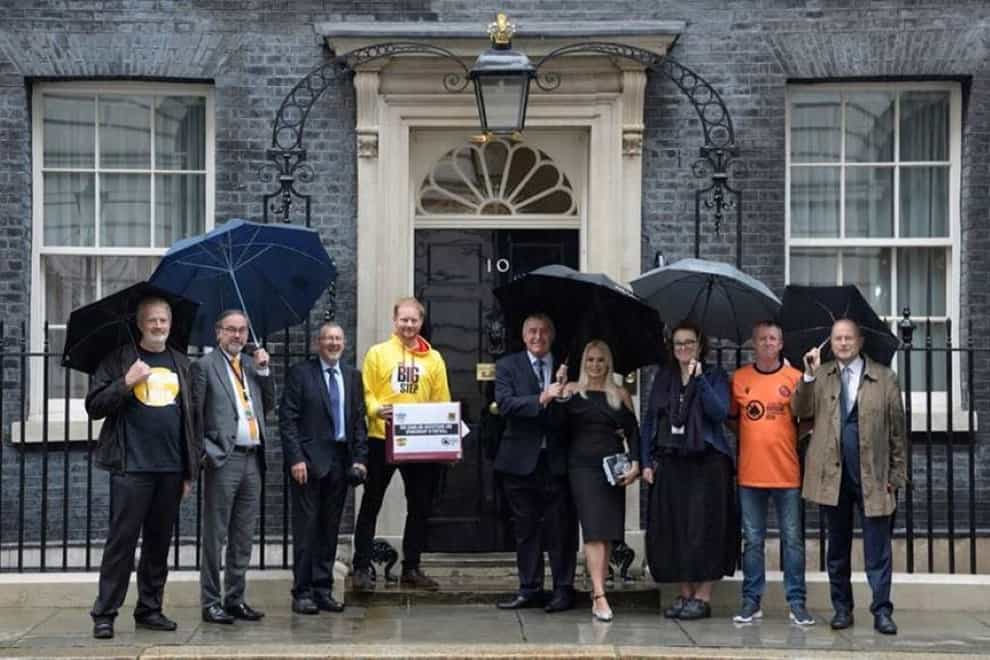 Campaigners, including Peter Shilton and his wife Steph (centre right) hand in a petition to Downing Street (Gambling with Lives/The Big Step)