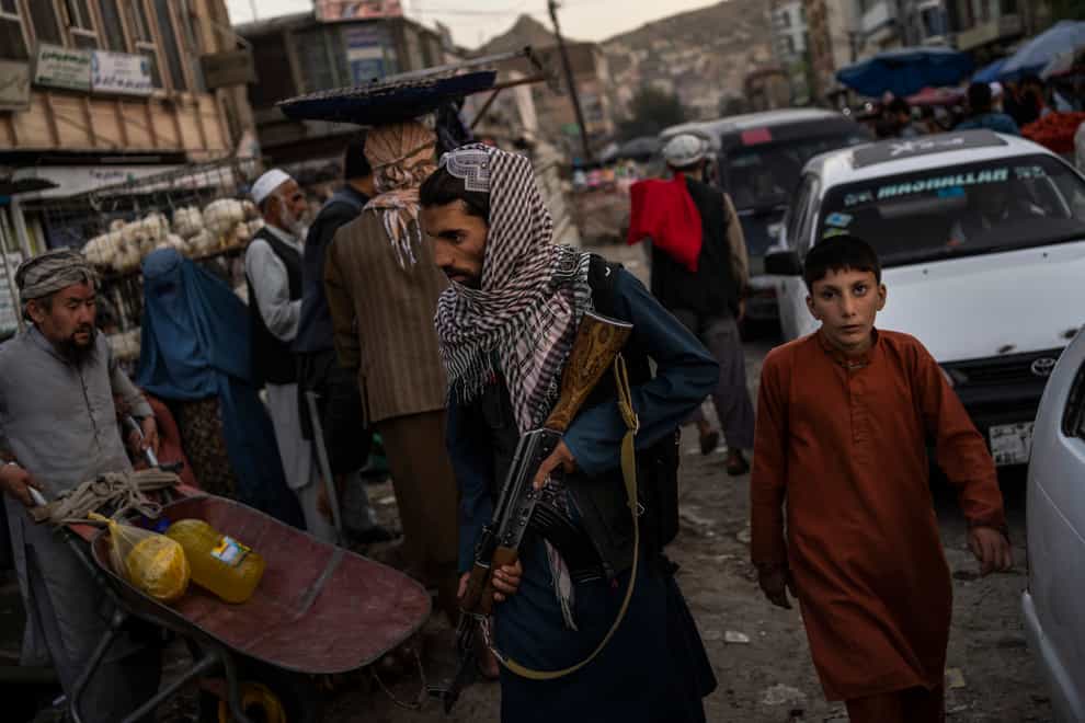 Taliban fighters patrol a market in Kabul (Bernat Armangue/AP)
