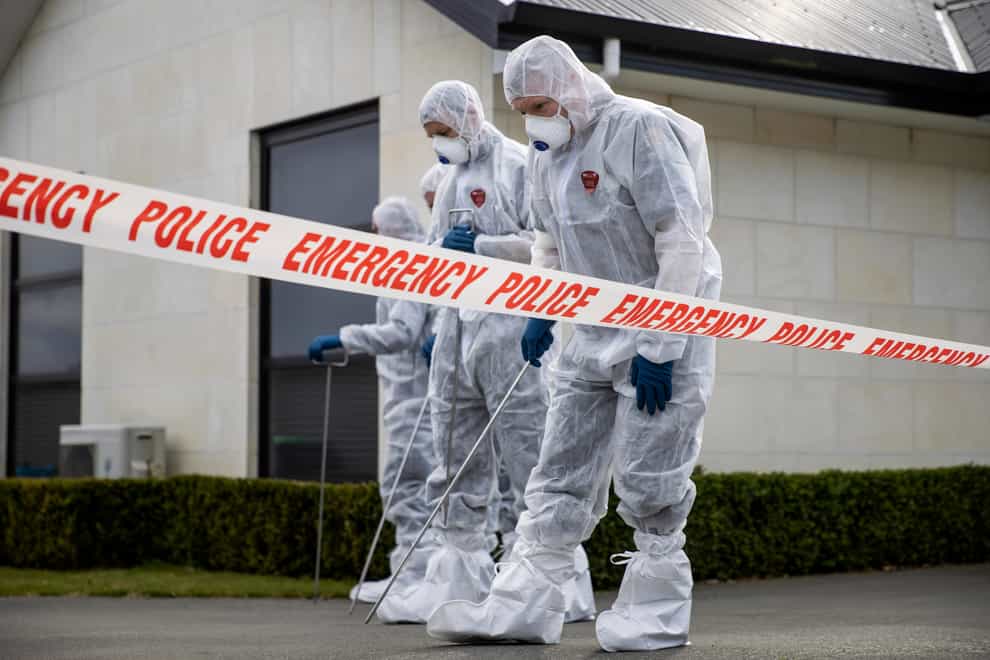Police search the driveway of a house where three children were found dead in the South Island town of Timaru, New Zealand (New Zealand Herald/AP)