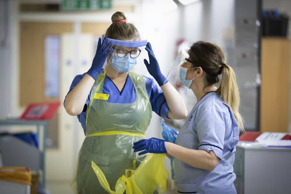 Nurses changing their PPE on Ward 5, a Covid Red Ward, at the Royal Alexandra Hospital in Paisley (PA)