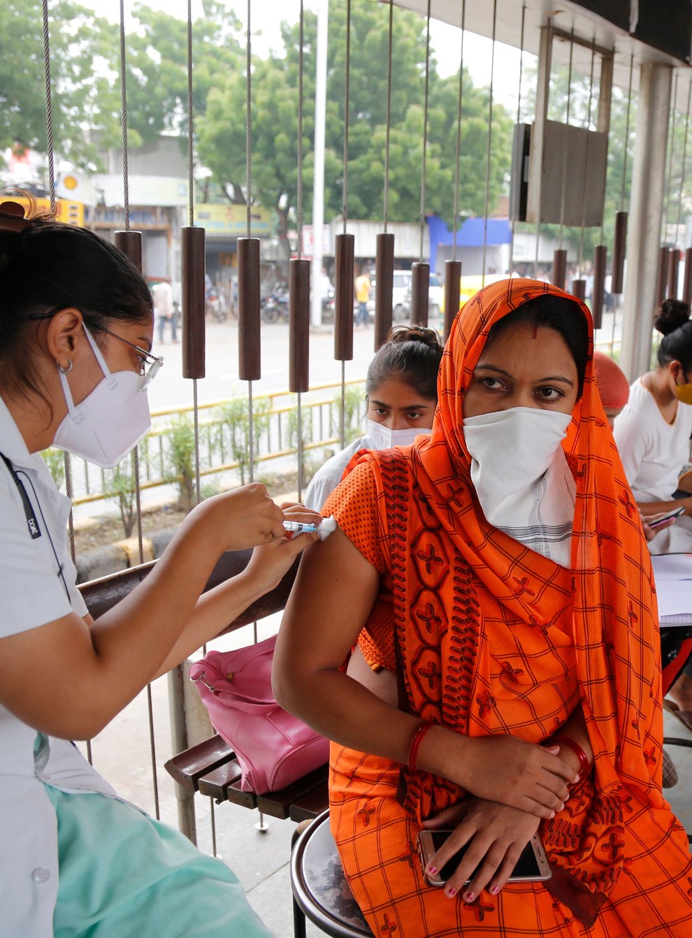 A health worker administers the vaccine for COVID-19 during a special vaccination drive by the municipal corporation at a bus stand in Ahmedabad, India, Friday, Sept. 17, 2021. (AP Photo/Ajit Solanki)