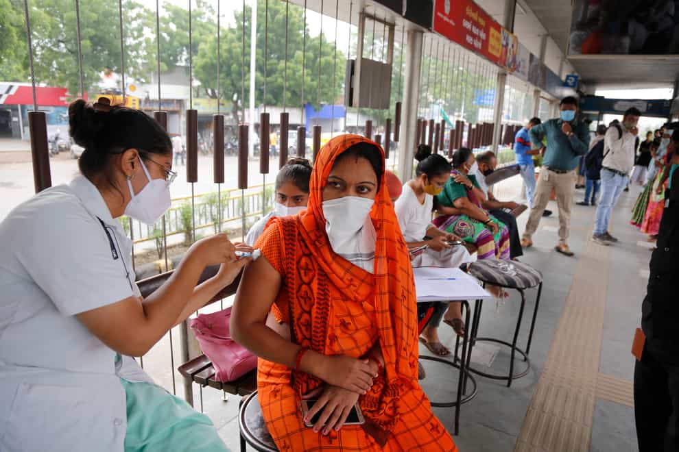 A health worker administers the vaccine for COVID-19 during a special vaccination drive by the municipal corporation at a bus stand in Ahmedabad, India, Friday, Sept. 17, 2021. (AP Photo/Ajit Solanki)