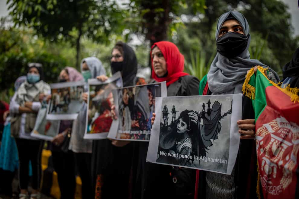 Afghan women hold placards during a protest against Pakistan and the Taliban takeover of Afghanistan, in New Delhi, India (AP)