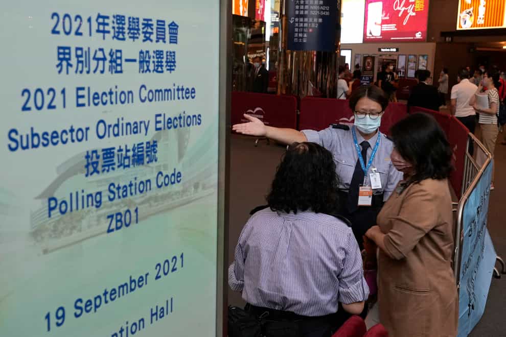 Voters enter a polling centre for the vote (Vincent Yu/AP/PA)
