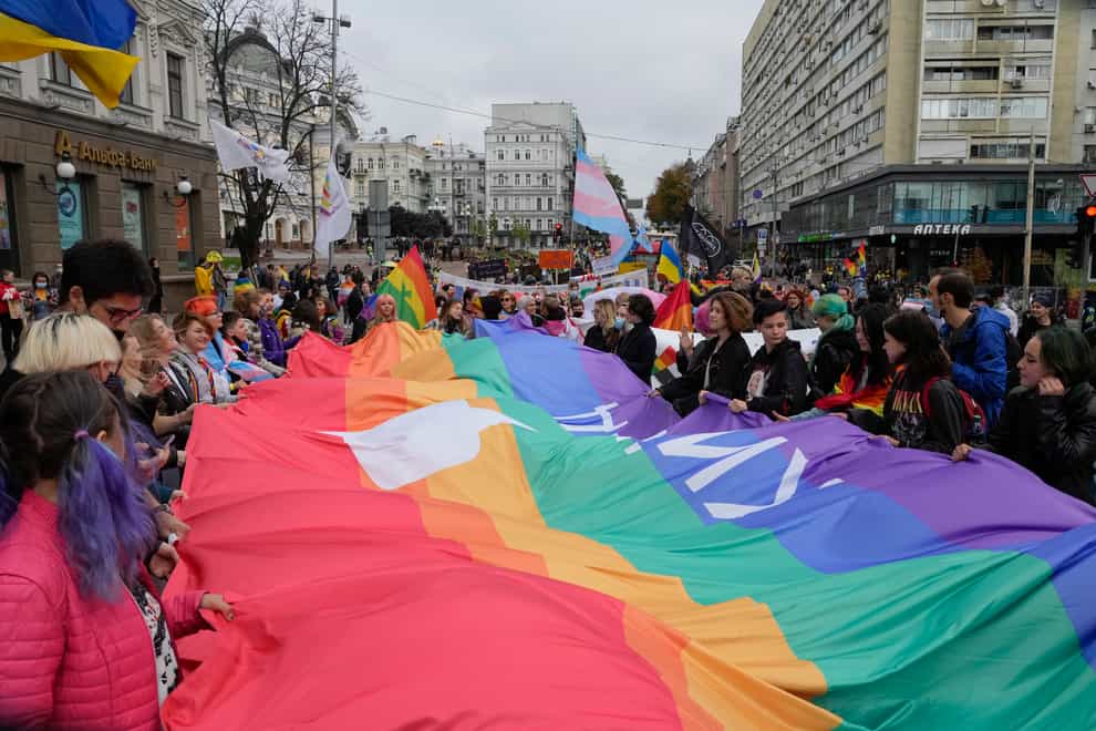 People take part in the annual Gay Pride parade, under the protection of riot police in Kyiv, Ukraine (Efrem Lukatsky/AP)