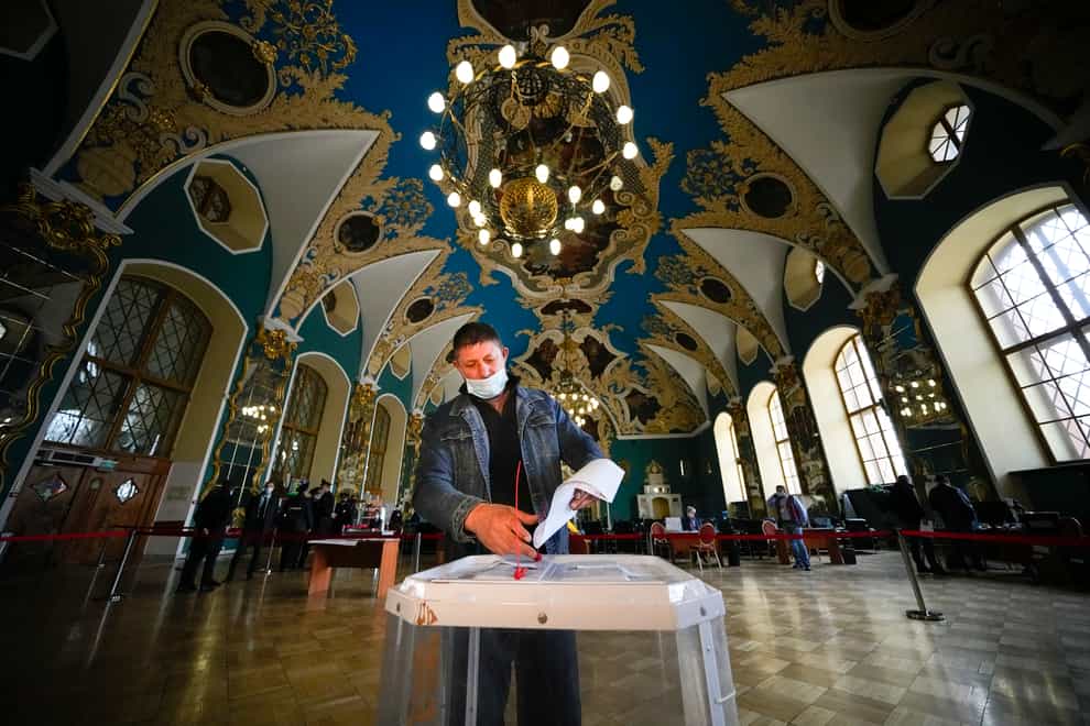 A man casts his ballot at a polling station at the Kazansky railway station during the Parliamentary elections in Moscow, Russia (Alexander Zemlianichenko/AP)