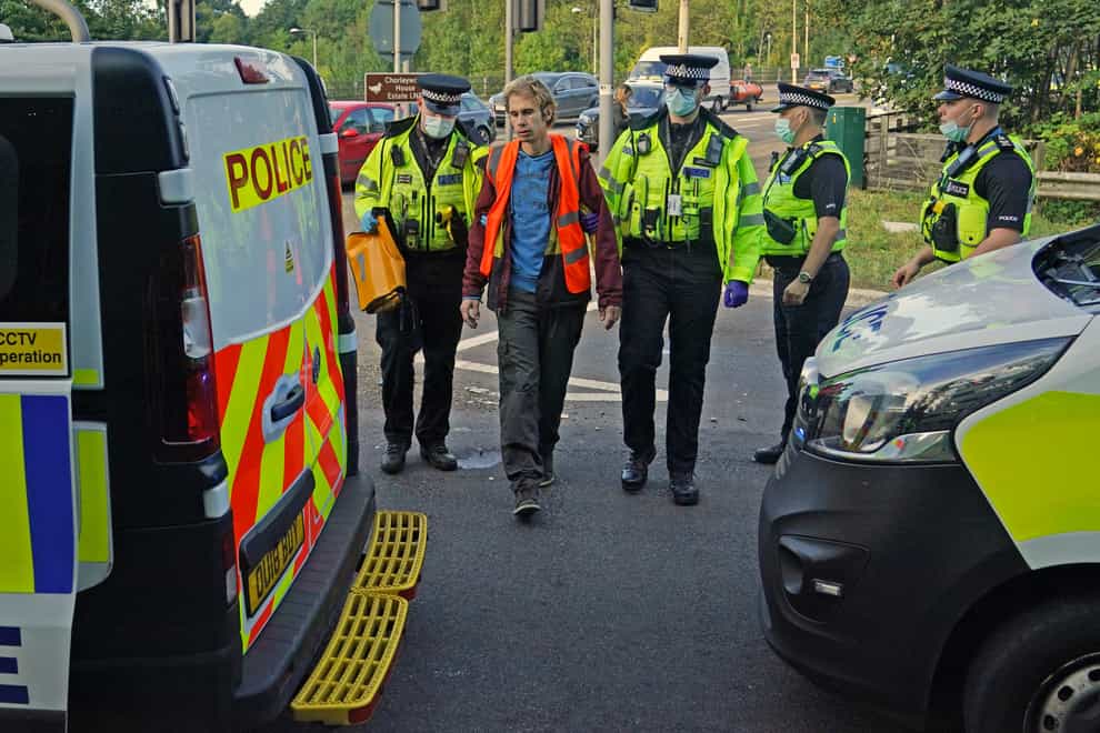 Officers lead a protester to a police van at a slip road at Junction 18 of the M25 (Steve Parsons/PA)
