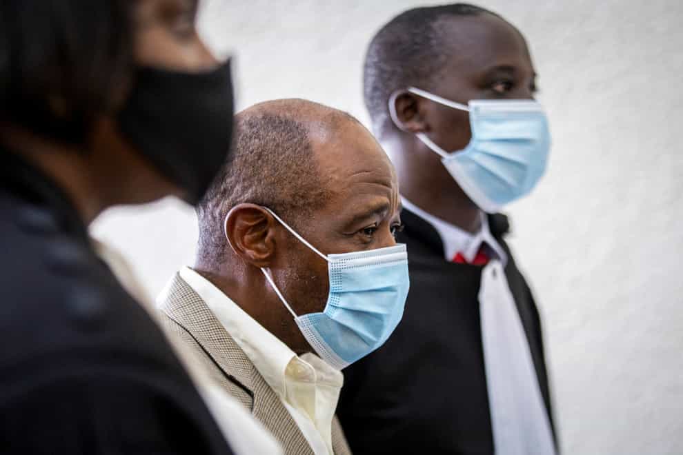 FILE – In this Monday, Sept. 14, 2020 file photo, Paul Rusesabagina, center, whose story inspired the film “Hotel Rwanda” for saving people from genocide, appears at the Kicukiro Primary Court in the capital Kigali, Rwanda. A court in Rwanda said Monday, Sept. 20, 2021 that Rusesabagina, who boycotted the announcement after declaring he didn’t expect justice in a trial he called a “sham”, is guilty of terror-related offenses. (AP Photo, File)