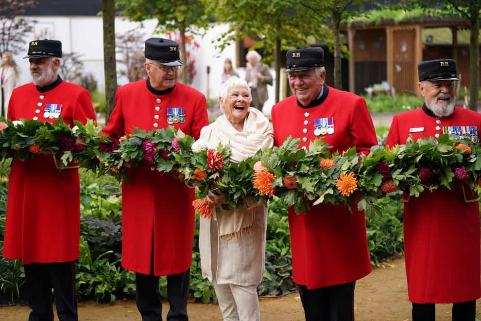 Dame Judi Dench with Chelsea Pensioners during the RHS Chelsea Flower Show press day, at the Royal Hospital Chelsea, London (Yui Mok/PA)