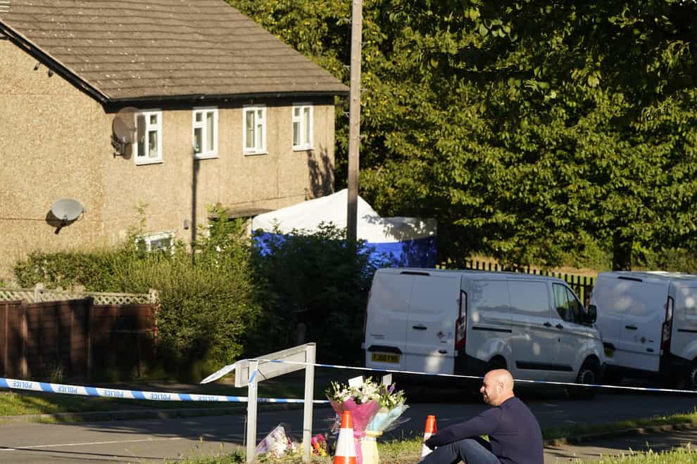 The father to some of the victims leaves flowers at the scene in Chandos Crescent, Killamarsh, near Sheffield, where four people were found dead at a house on Sunday. Derbyshire Police said a man is in police custody and they are not looking for anyone else in connection with the deaths. Picture date: Monday September 20, 2021.