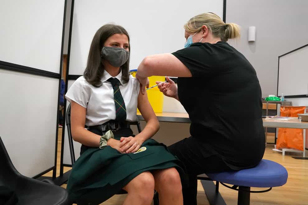 Molly Rowe, 15, from St John Ogilvie High School in Hamilton receives her first vaccination (Andrew Milligan/PA)
