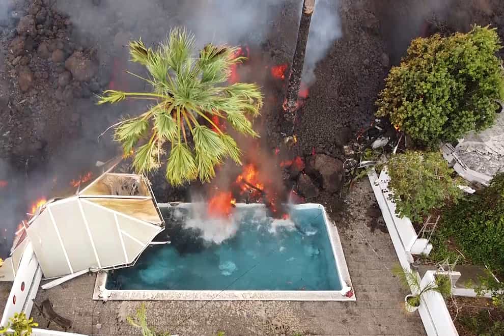 Hot lava reaches a swimming pool on the island of La Palma (Europa Press via AP)