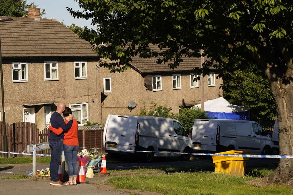 The father to some of the victims leaves flowers at the scene in Chandos Crescent, Killamarsh, near Sheffield, where four people were found dead at a house on Sunday (Danny Lawson/PA)