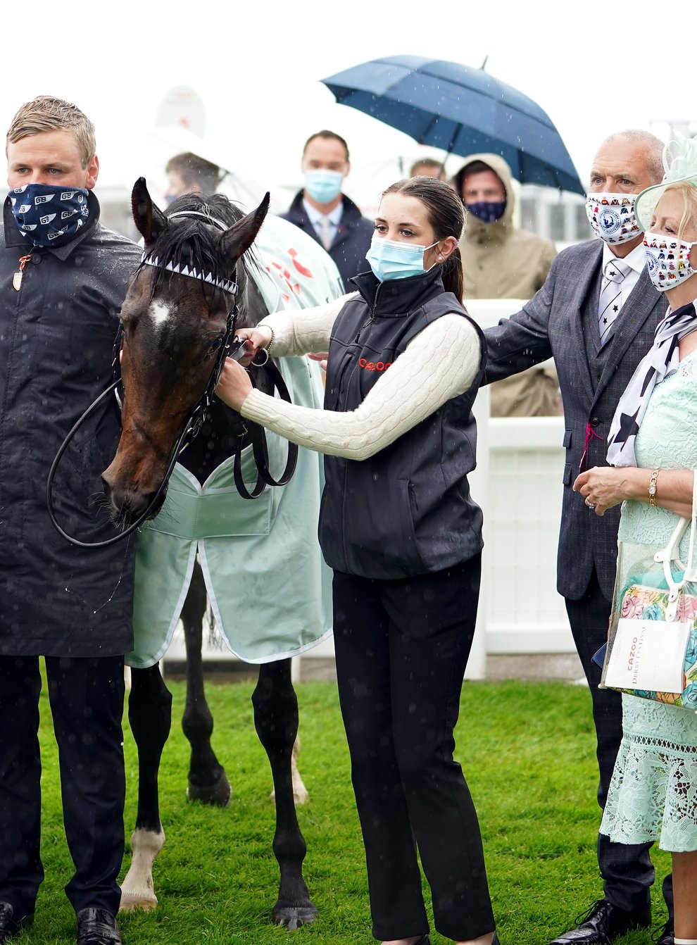 George Boughey (centre) with Oscula after her win at Epsom (Mike Egerton/PA)
