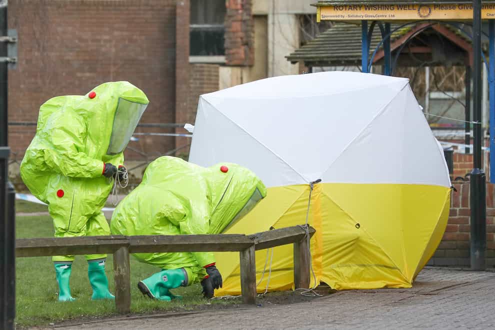 File photo dated 08/03/18 of personnel in hazmat suits working to secure a tent covering a bench in the Maltings shopping centre in Salisbury, where former Russian double agent Sergei Skripal and his daughter Yulia, were found critically ill by exposure to Novichok nerve agent. A third Russian spy faces charges of attempted murder over the Salisbury Novichok poisonings. (Andrew Matthews/PA) Issue date: Tuesday September 21, 2021.