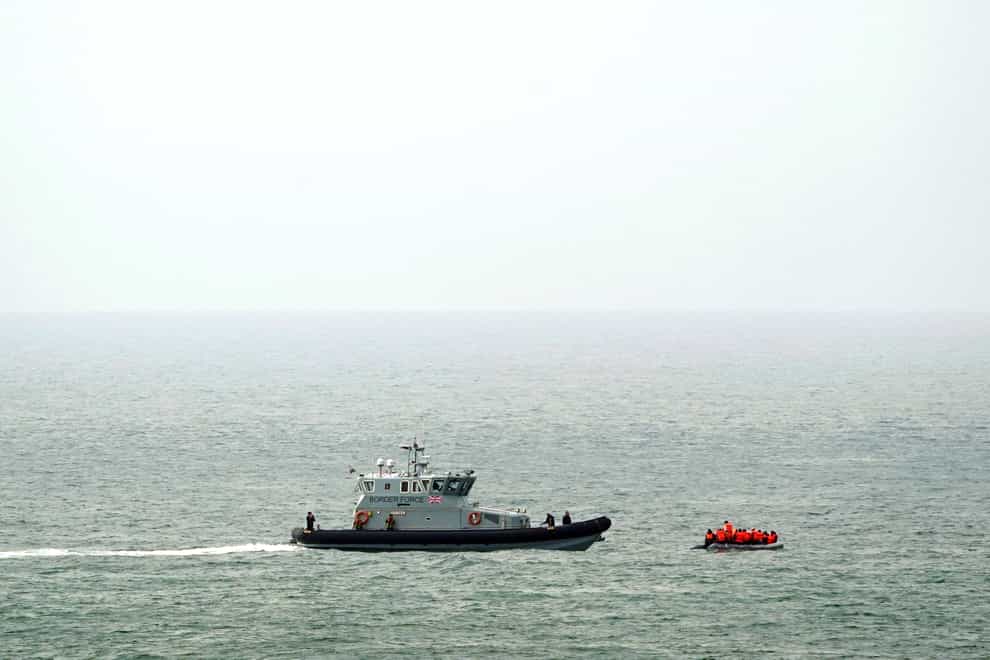 A Border Force vessel intercepts a group of people thought to be migrants in a small boat off the coast of Dover in Kent. (Gareth Fuller/PA)