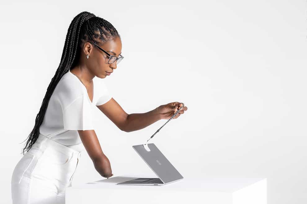 Microsoft’s Surface Adaptive kit being used to help open a laptop (Microsoft/PA)