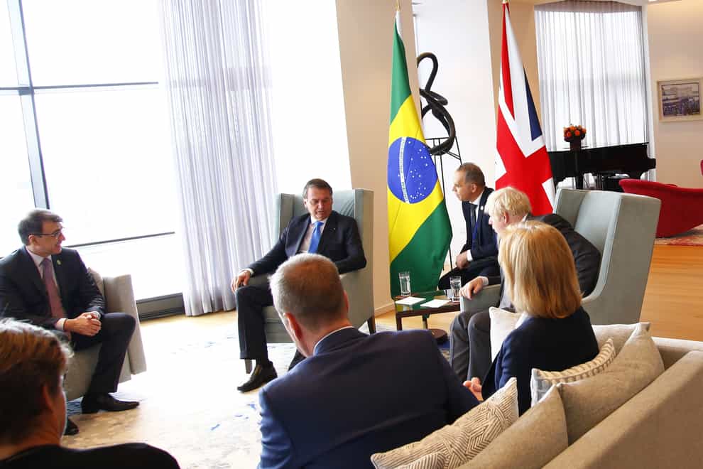 Boris Johnson (centre) with Brazil’s president Jair Bolsonaro (second left) (Michael M. Santiago/PA)