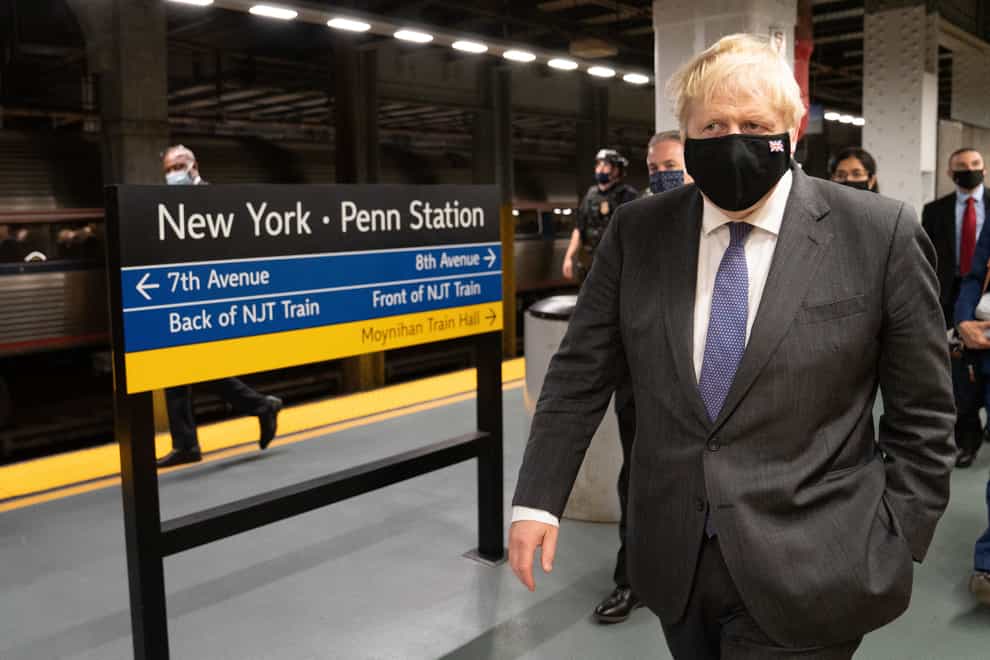 Boris Johnson prepares to board a train from Penn Station in New York to Washington DC (Stefan Rousseau/PA)