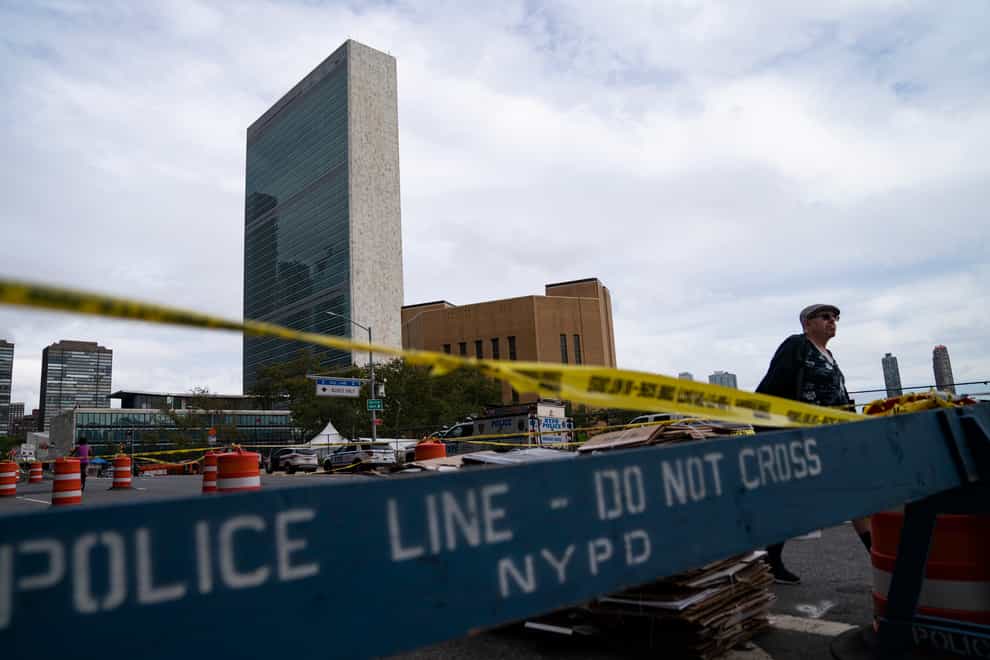 A pedestrian passes police barricades surrounding the United Nations headquarters (John Minchillo/AP)