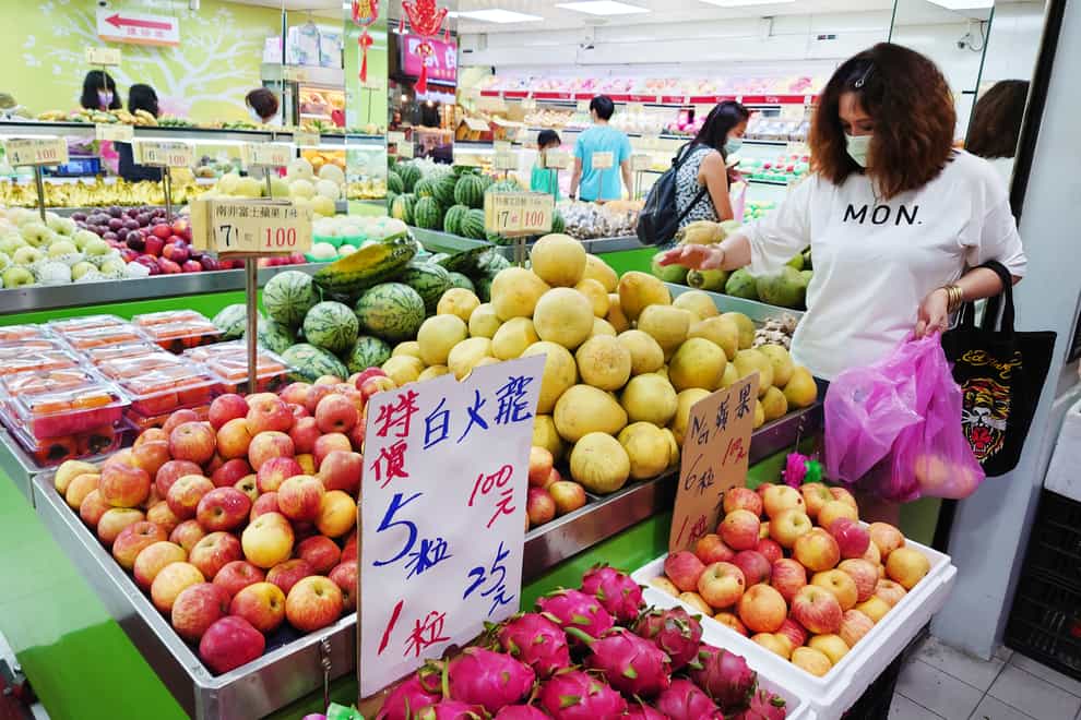 People buy fruit at a grocery store in Taipei, Taiwan (Chiany Ying-ying/ AP)