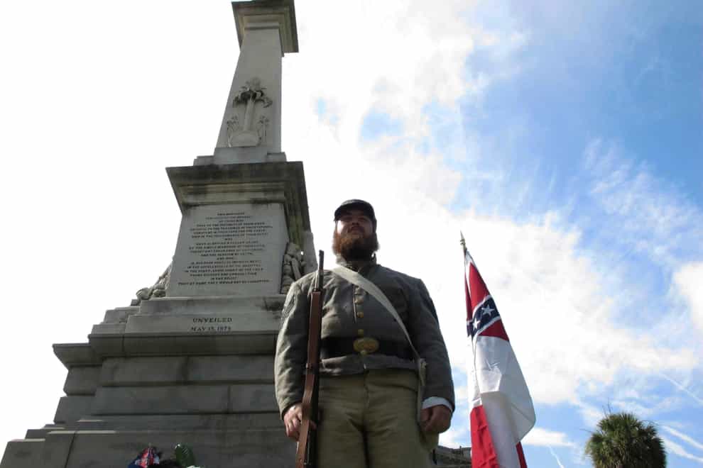 Cameron Maynard stands at attention by the monument to Confederate soldiers at the South Carolina Statehouse in Columbia, South Carolina (Jeffrey Collins/AP)