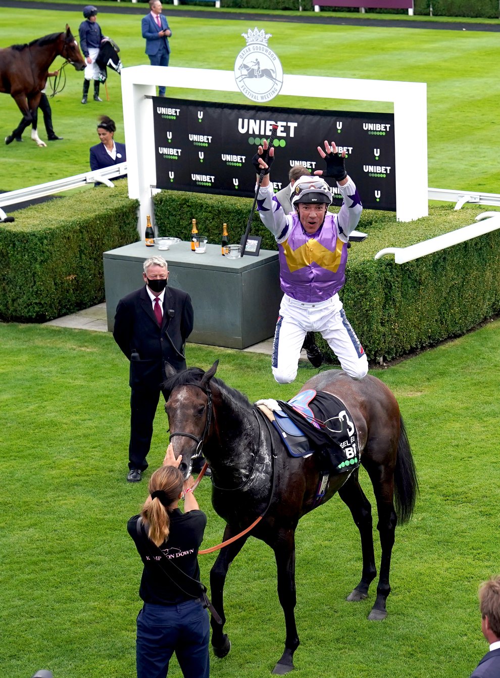 Frankie Dettori leaps from Angel Bleu after victory in the Vintage Stakes at Goodwood (John Walton/PA)
