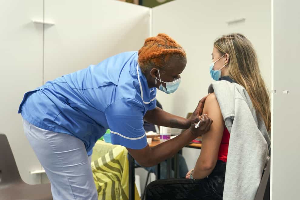 Nurse Marvis Birungi gives a Covid vaccine to Oxford Brookes University student Eleanor Seddon in a pop-up clinic at the university’s Headington Campus (Steve Parsons/PA)