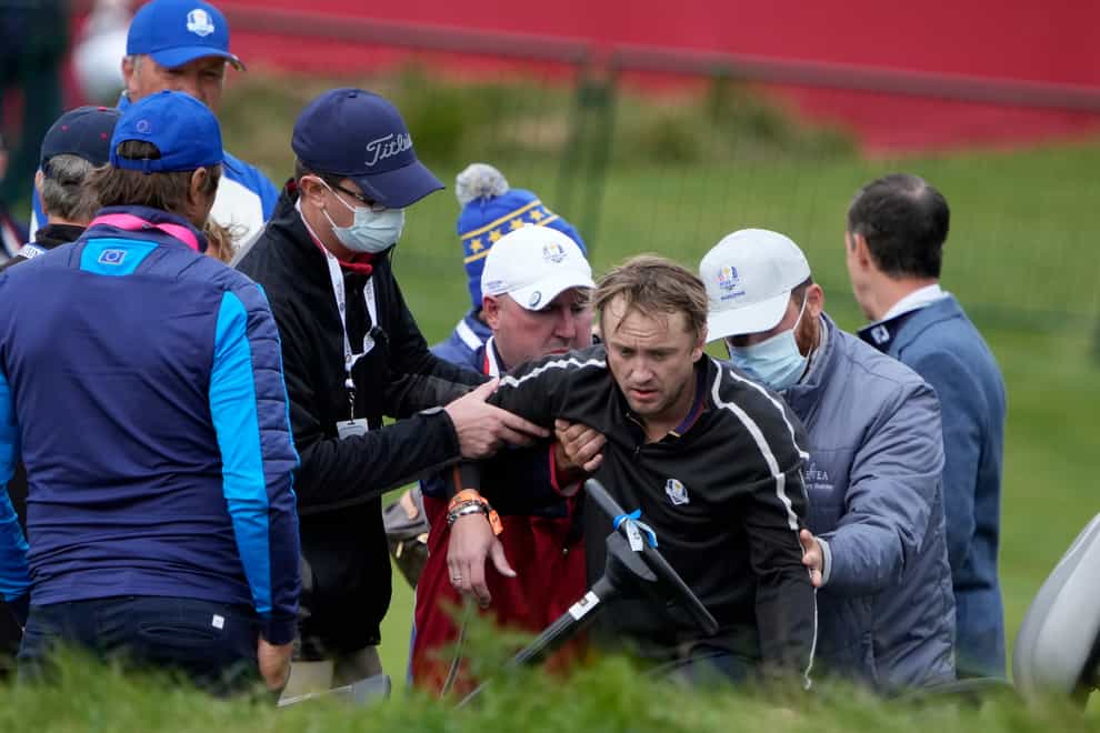 Actor Tom Felton is helped after collapsing on the 18th hole during a practice day at the Ryder Cup at the Whistling Straits Golf Course (Ashley Landis/AP)