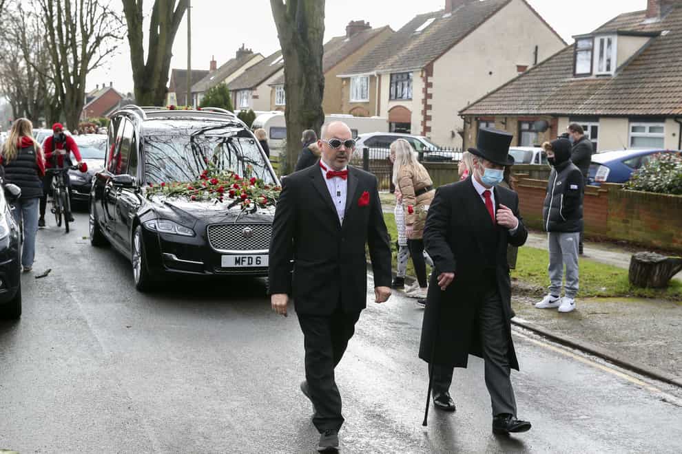 The funeral procession of Olly Stephens slows at All Hallows Road, Reading to receive floral tributes, before making its way to Reading Crematorium (Steve Parsons/PA)